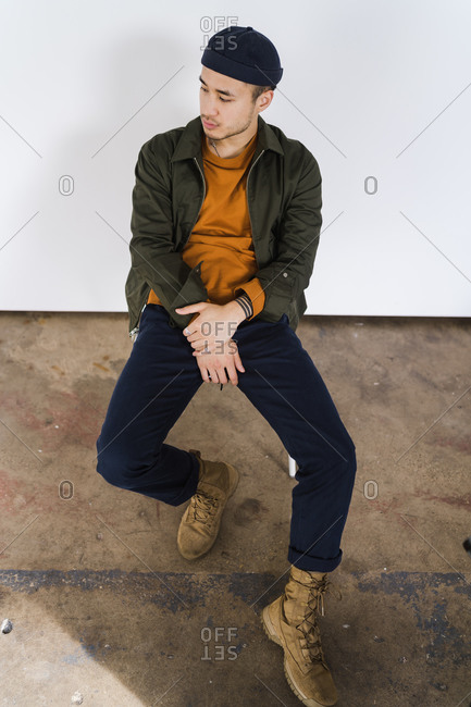Man Posing in Ripped Jeans and Strap Trainers · Free Stock Photo