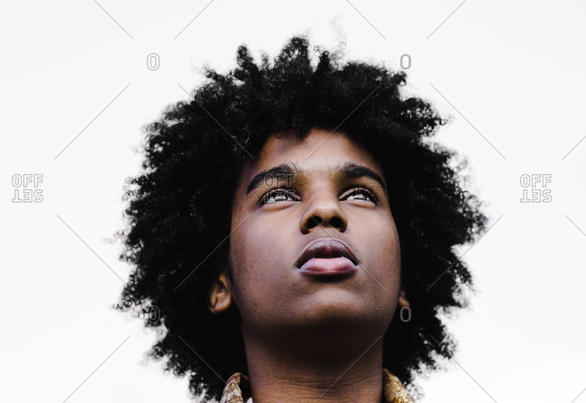 A close up portrait shot of a young black Muslim man looking up into sky