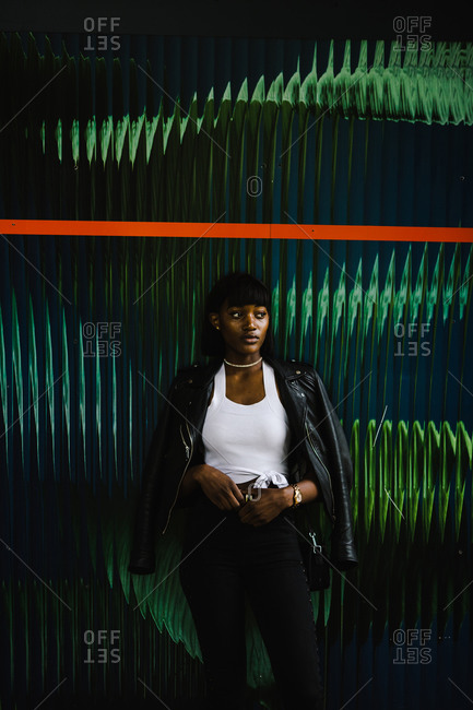 Black woman wearing a leather jacket posing
