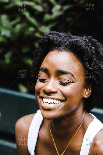 Vertical portrait of a black woman with a grin on her face