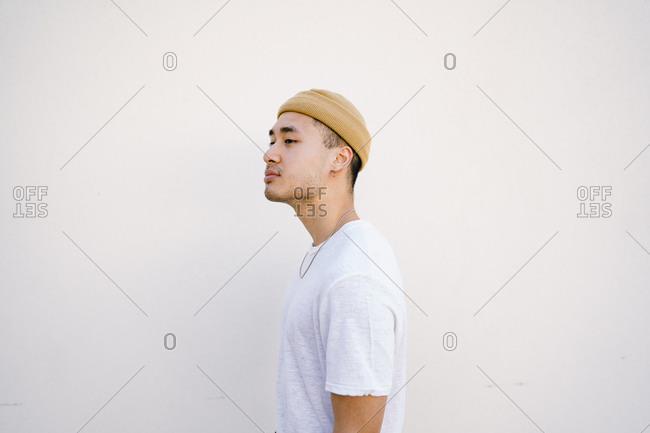 Stylish young man posing wearing a beanie cap