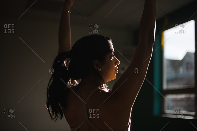 Close up portrait of a woman preforming yoga in a studio