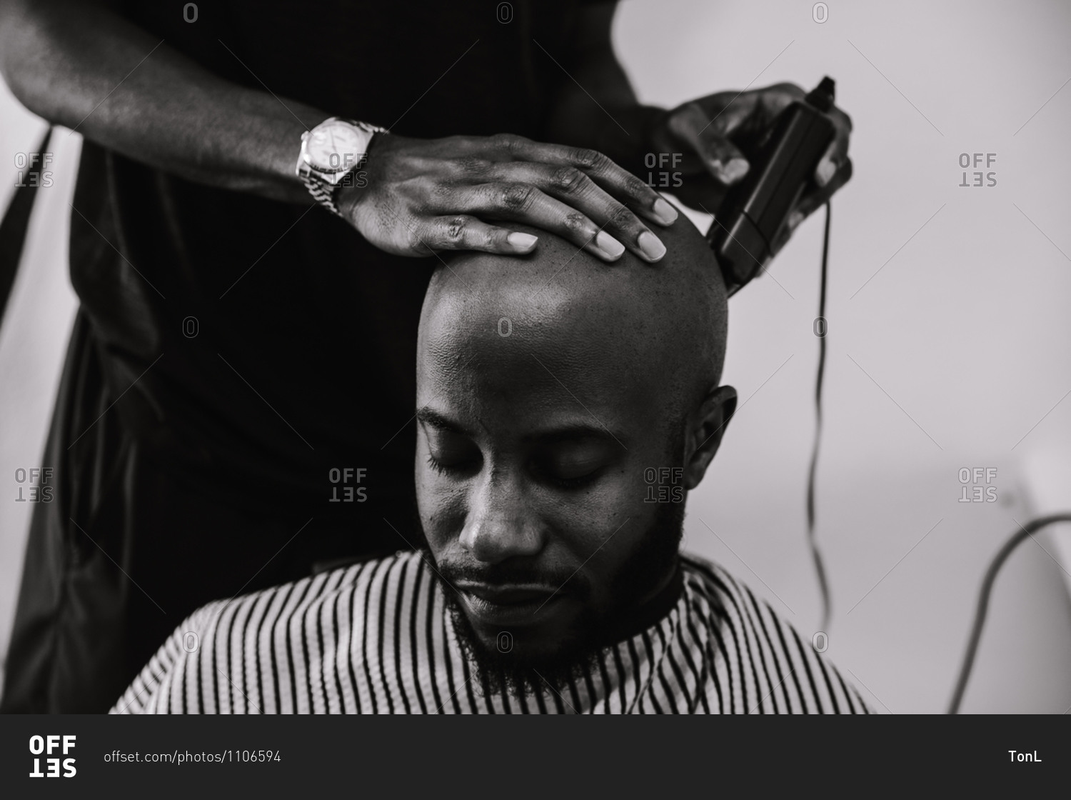 Black and white shot of the close up of a barber shaving a male client ...