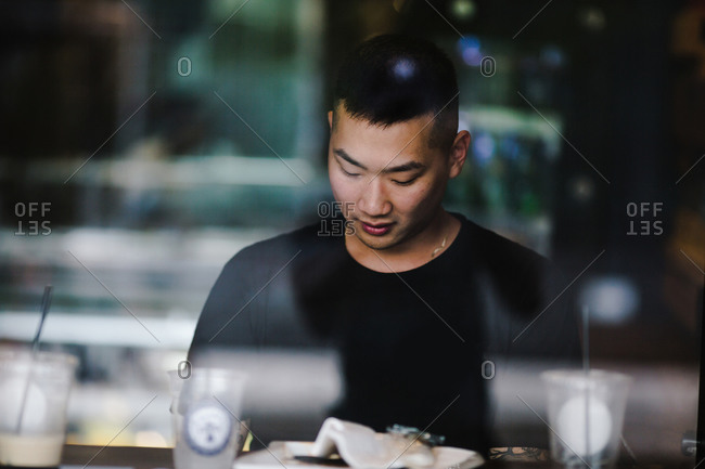 Premium Photo  Unrecognizable young man stands by the window