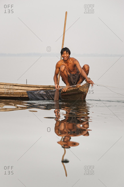 A fisherman pulls in his net on Indawgyi lake in Kachin State in Burma, also known as Myanmar