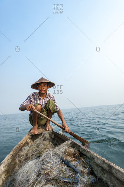 A fisherman paddles home across Indawgyi lake