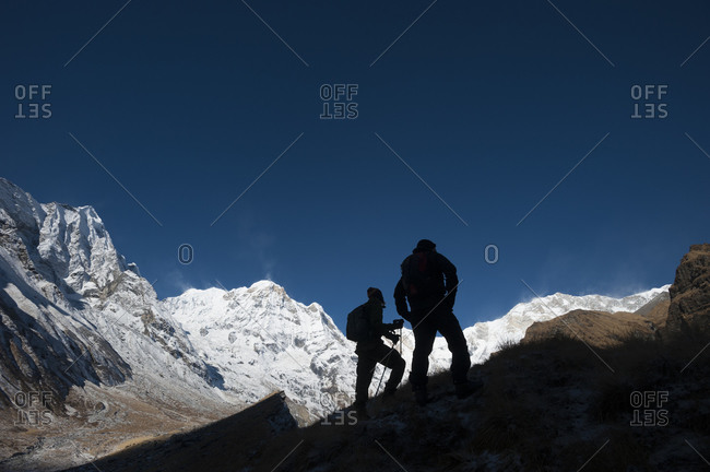Trekkers stop and admire the view of Annapuna 1 and Annapurna South