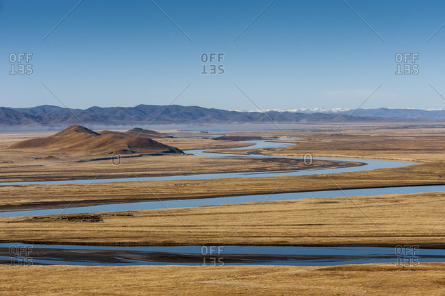 The Yellow River meanders through the open plains in Sichuan Province in China. The tiny black dots are Yaks grazing.