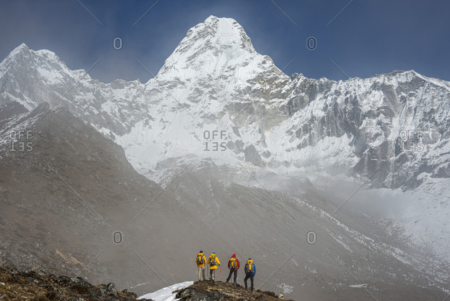 A team of climbers gaze up at the prospect ahead, Ama Dablam in the Everest region of Nepal