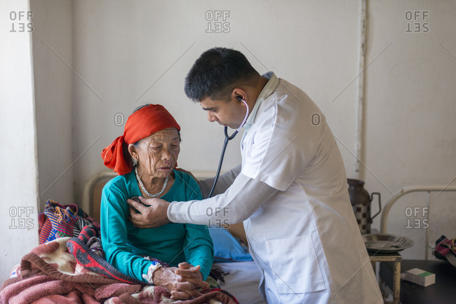 A doctor consults an old woman in a rural hospital in Nepal