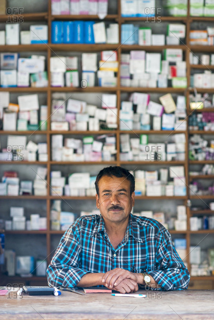 A man working in a dispensary next to a hospital in west Nepal