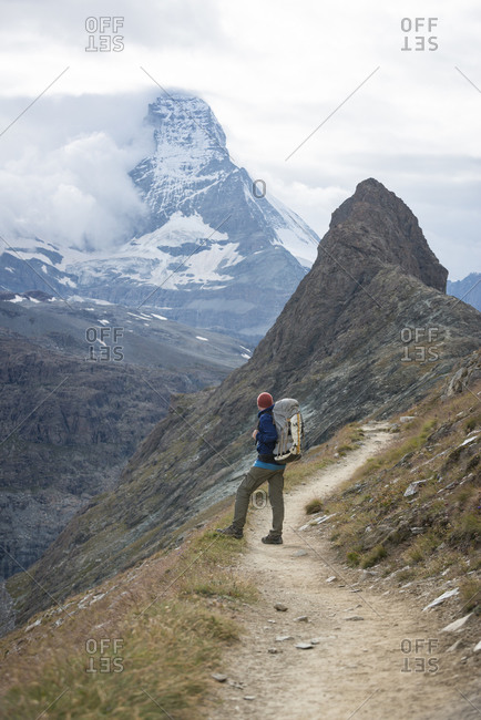 Trekking on the trail beside the Gorner Glacier with views of the Matterhorn in the distance