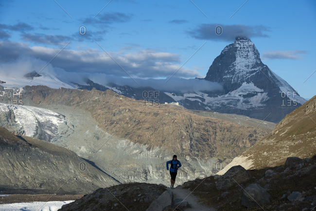 Running on the trail beside the Gorner Glacier with views of the Matterhorn in the distance