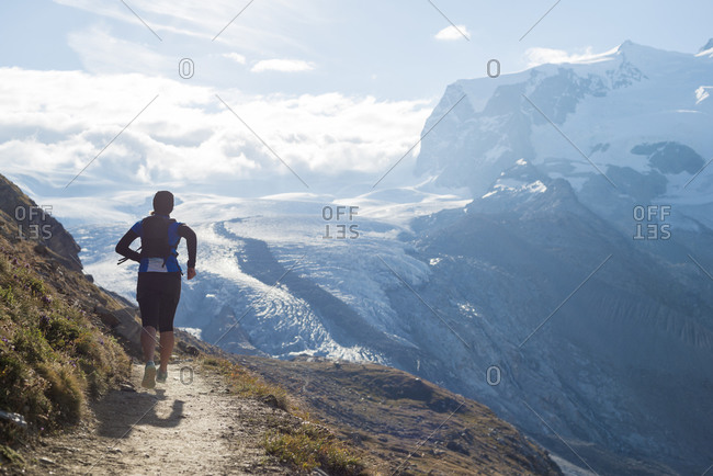 Running on the trail beside the Gorner Glacier with a view of Monte Rosa in the distance