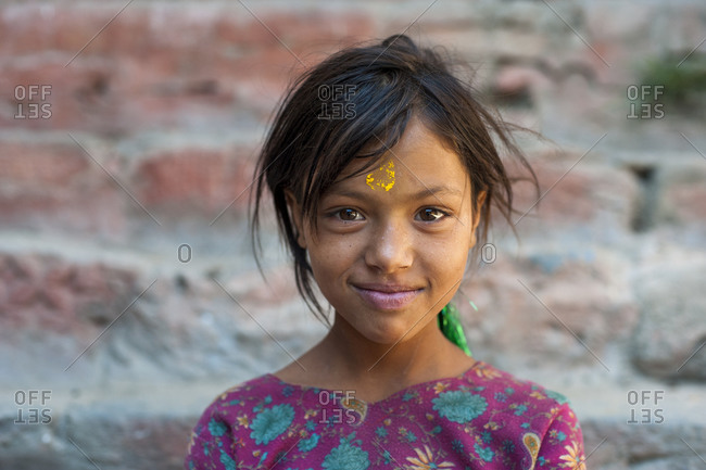 A pretty little girl in the remote Dolpa region of Nepal wearing Tikka on her forehead to celebrate a festival