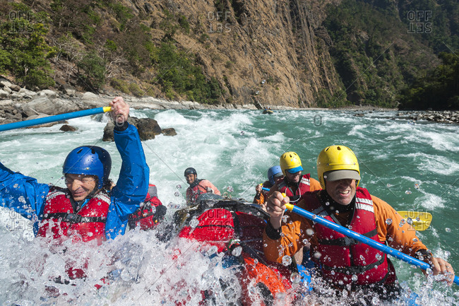 Rafters get splashed as they go through some big rapids on the Karnali river in Nepal