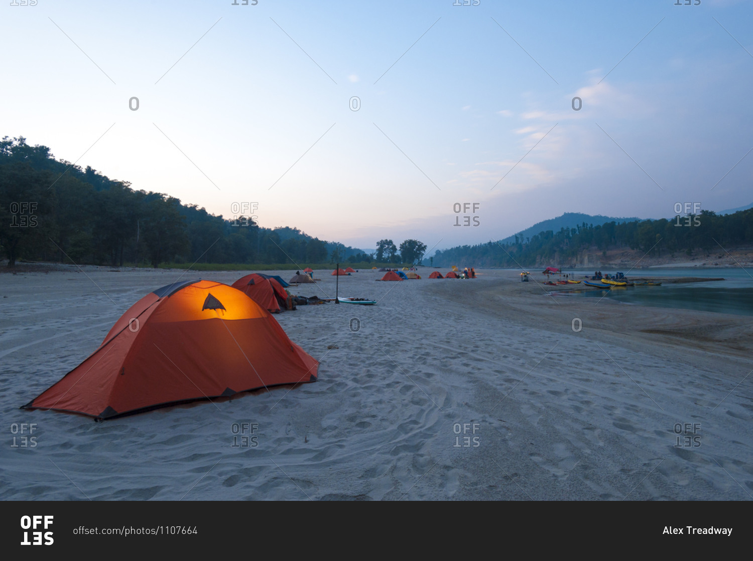 A tent glows in the twilight during a rafting expedition down the Karnali river in far west Nepal