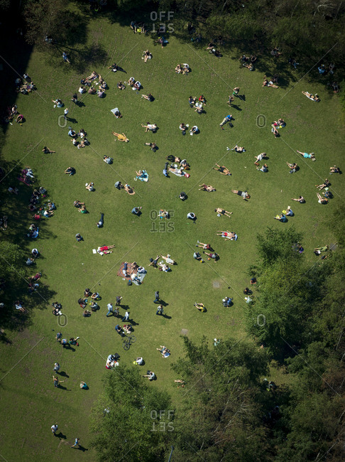 An aerial view of people sunbathing in a park in London