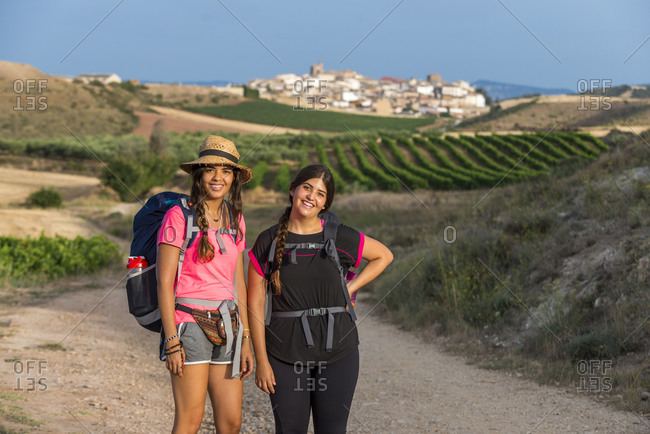 Pilgrims walking the trek called the Camino de Santiago, also known as The Way towards little village of Cirauqui