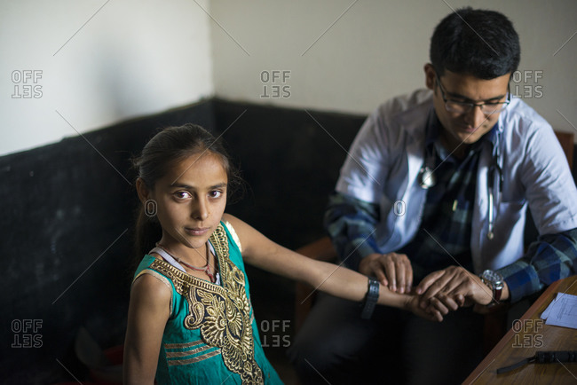 Young girl being examined by male doctor at a hospital in Nepal