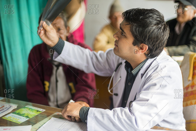 Doctors discuss an x-ray with a patient in a rural hospital in Nepal