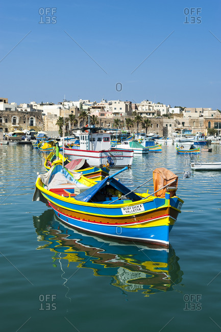 Marsaxlokk, South Eastern Region, Malta - May 31, 2012: Colorful fishing boats in the fishing village of Marsaxlokk