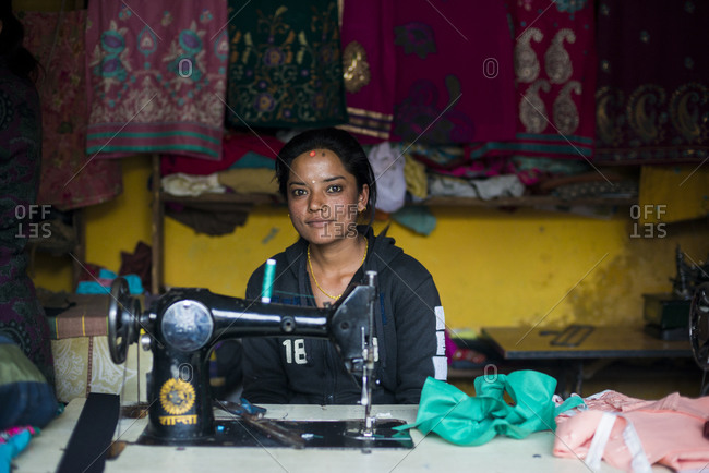 Myagdi, Myagdi, Beni district, Nepal - November 26, 2013: A woman works on a sewing machine in a village