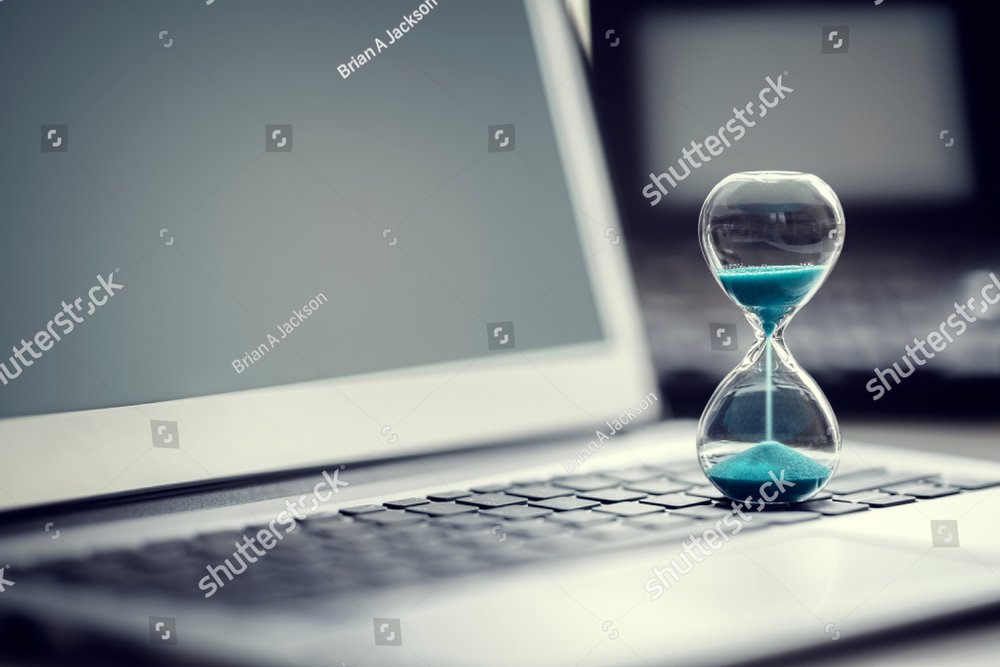 Hourglass on laptop computer concept for time management and countdown to deadline