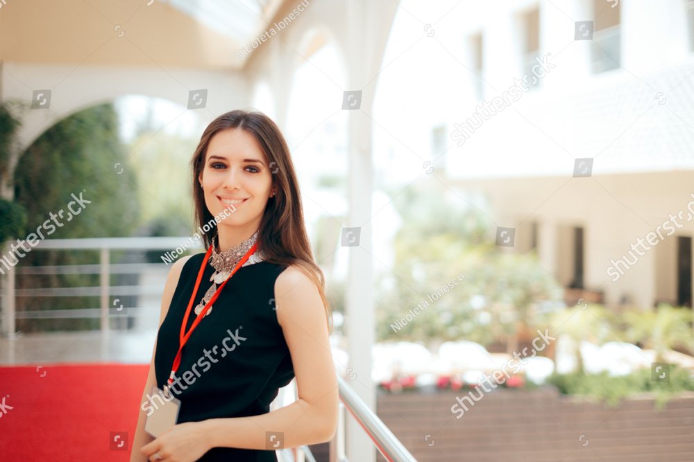 Event Planner Coordinator PR Specialist Employee at Formal Event 
Authorized manager wearing a badge welcoming guests at hotel entrance
