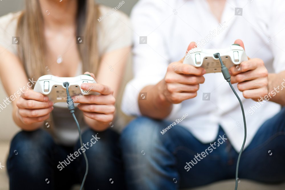 Young couple playing video games in their apartment