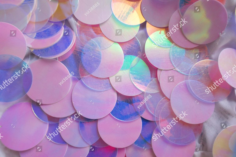 Sequins macro background.large sequins in blue and pink colors.Fabric with  sequins in pastel tone.ridescent fabric.Scales background. Blue Background  with shiny sequin Background Stock Photos