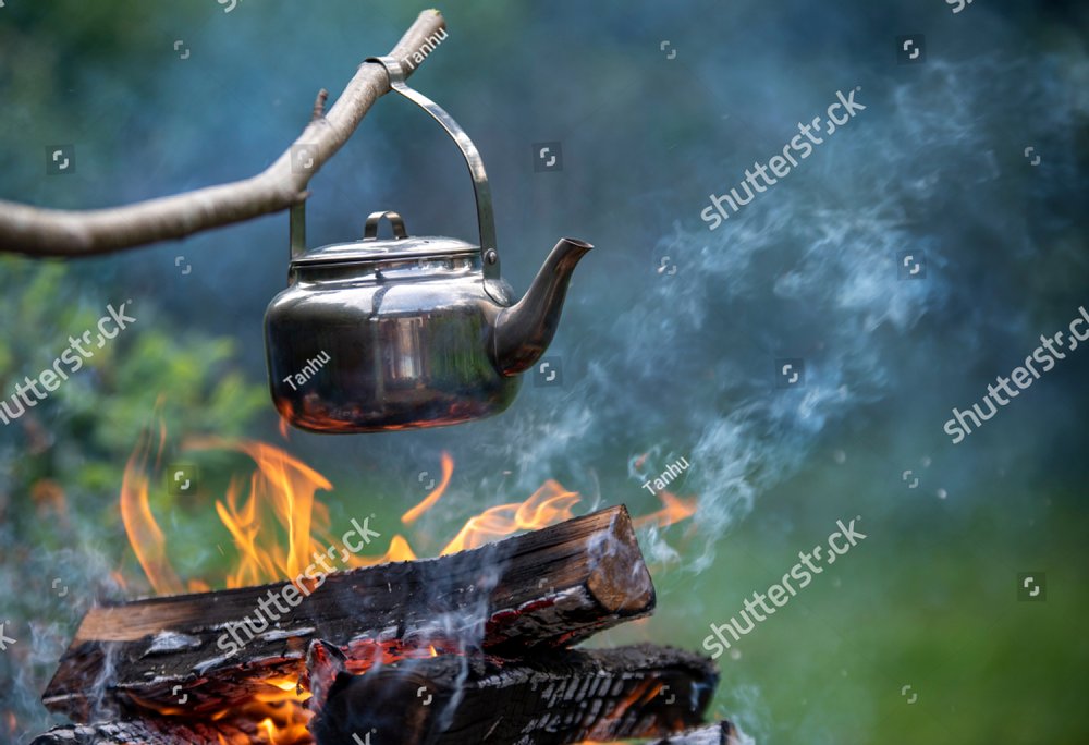 Coffee pot on camping fire, a tea kettle is over a campfire Sports &  Recreation Stock Photos