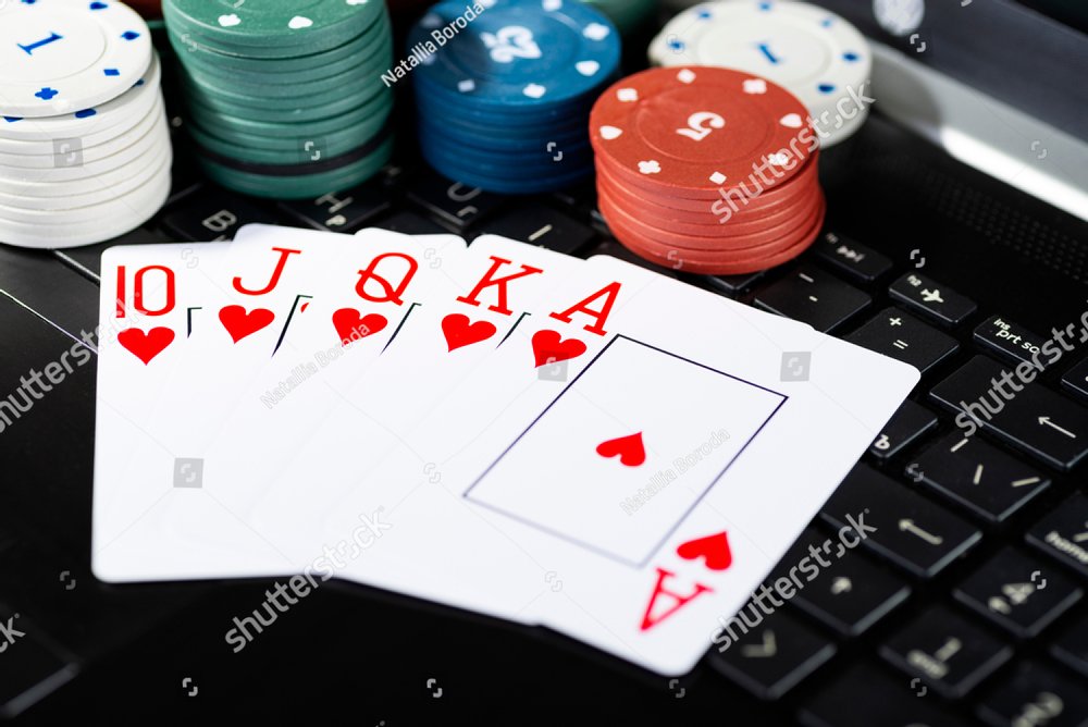 Online gaming platform, casino and gambling business. Cards, dice and  multi-colored game pieces on laptop keyboard. Sports & Recreation Stock  Photos