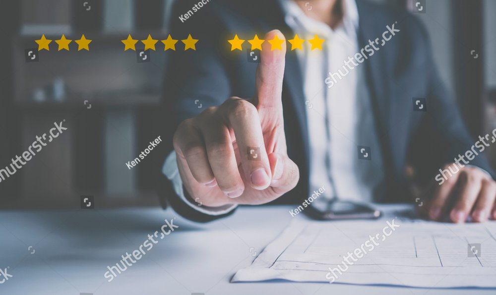 Customer review good rating concept hand pressing five star on visual screen and positive customer feedback testimonial.	