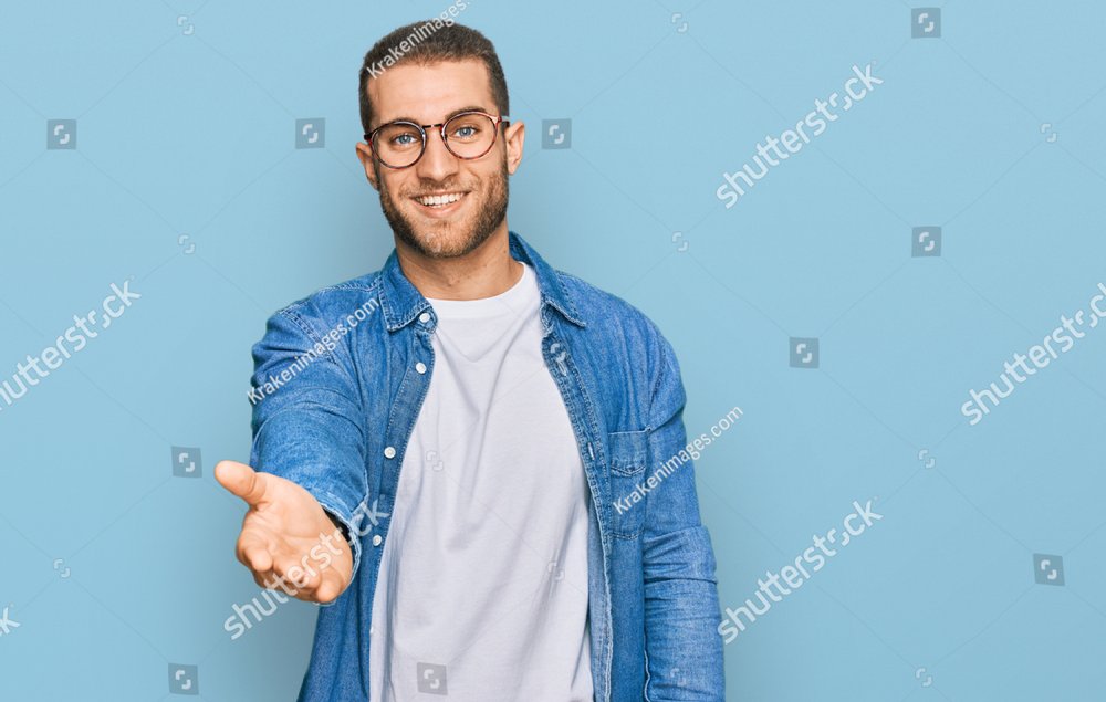 Young caucasian man wearing casual clothes smiling cheerful offering palm hand giving assistance and acceptance. 