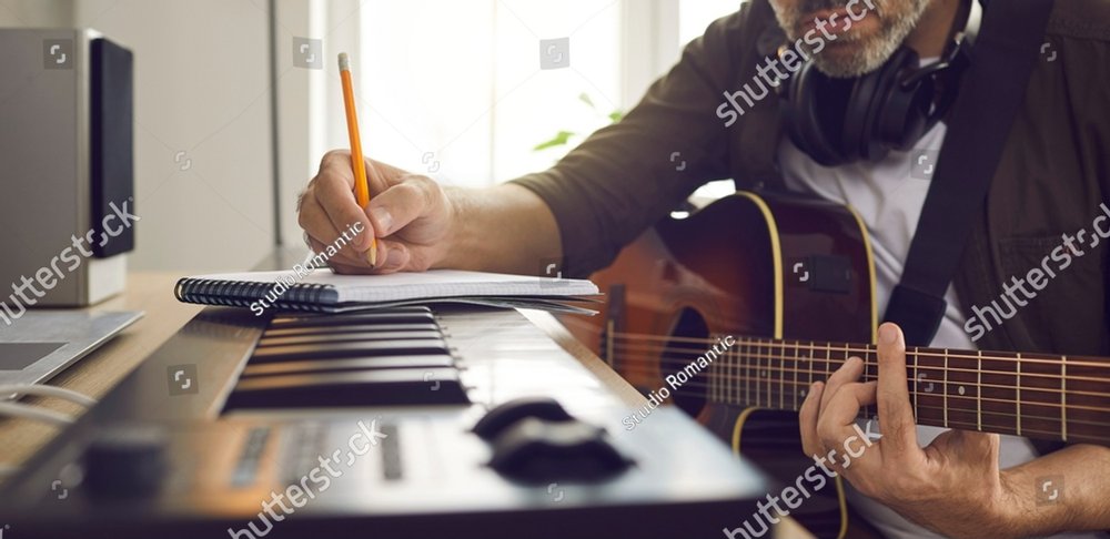 Musician writing music. Songwriter who's following his passion sitting by electronic keyboard in home studio, holding pencil, picking guitar strings, thinking of lyrics for new song. Banner background