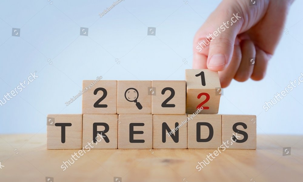 2022 trend concept. Hand flip wooden cube change year 2021 to 2022. Beautiful white background, copy space. Used for banner in trend concept in new year for monitoring new business opportunities.