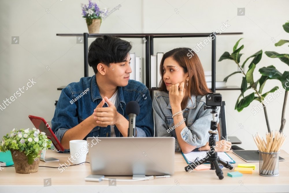 Young asian vlogger influencers record video online live streaming and broadcasting in social networks. Sweet couple have eye contact to each other to celebrate valentine's day.