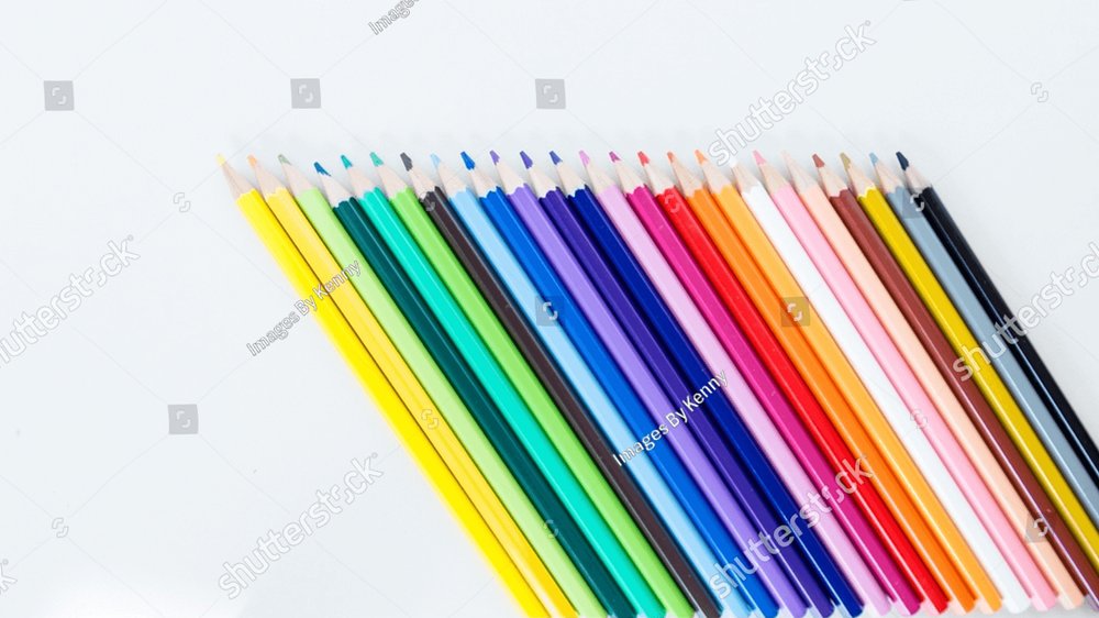 Colored pencil crayons in a row on white background Background Stock Photos