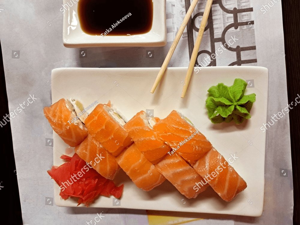 Sushi with salmon and wasabi on a white plate. Japanese and Chinese ...