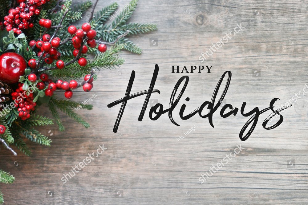Happy Holidays Text with Christmas Evergreen Branches and Berries in Corner Over Rustic Wooden Background