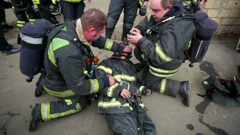 MOSCOW, RUSSIA - MARCH 25, 2015: Training of rescue workers, providing first aid for wounded firefighter.