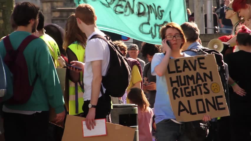 BRISTOL - May 13: Protest Against Conservative Government & Austerity: Young Woman with 'Human Rights' Sign on May 13, 2015 in Bristol, England. | Shutterstock HD Video #10000319