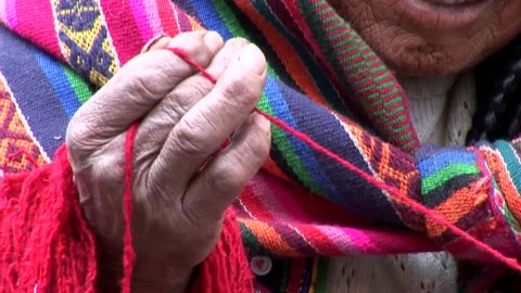 video footage of a indigenous woman spinning wool in the streets of Cuzco, Peru. February 2007