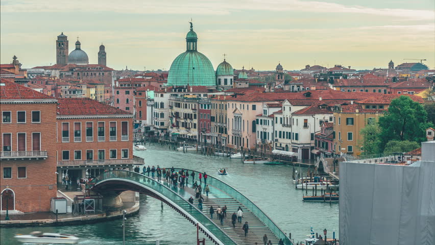 VENICE, ITALY - MAY 2015: Time lapse, people walks across constitution bridge over the grand canal in Venice, Italy. The bridge connects the railway station with the city