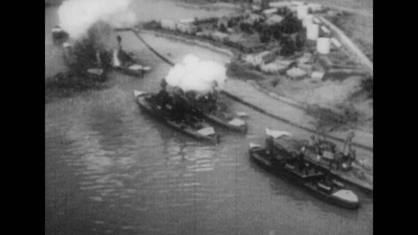 UNITED STATES 1940s: Aerial view of ships being bombed / Japanese plane in air / Aerial of Pearl Harbor / Plane in air / Planes fly through smoke.