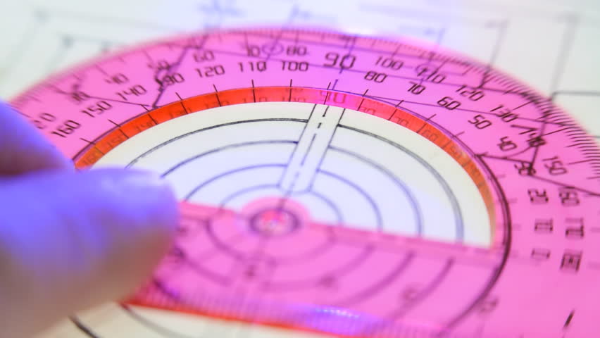 Designer measures the angle of the red protractor and pencil draws a line. Closeup. Shallow depth of field. The camera moves around