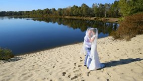 honeymoon bride groom kisses. river bank. sunny summer day. full hd video footage 1920x1080