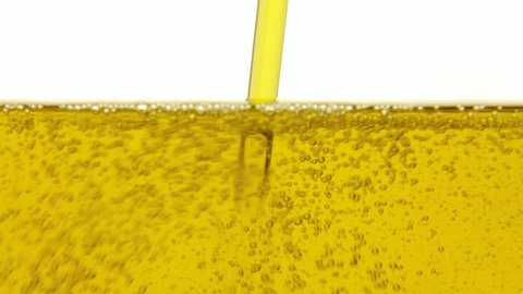 Filling a jug with healthy yellow olive oil. Fast macro detail shot.
