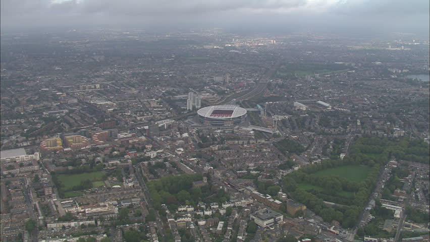 AERIAL United Kingdom-Emirates Stadium 2006: New Arsenal Emirates football Stadium and surrounding area including Finsbury park, zooming in to look onto football pitch within stadium Royalty-Free Stock Footage #10043612